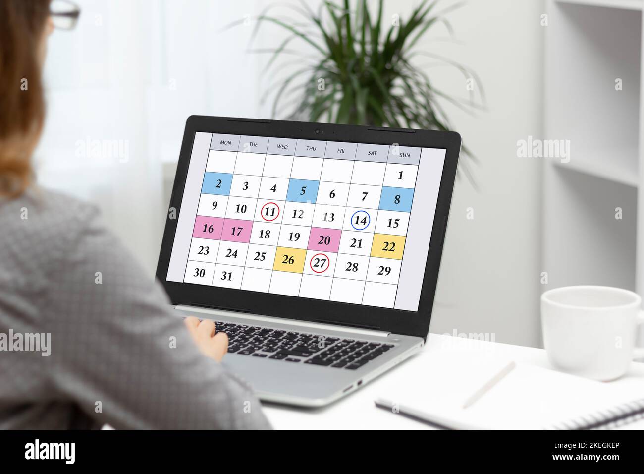 Woman planning monthly business meetings, schedule and goals using ...