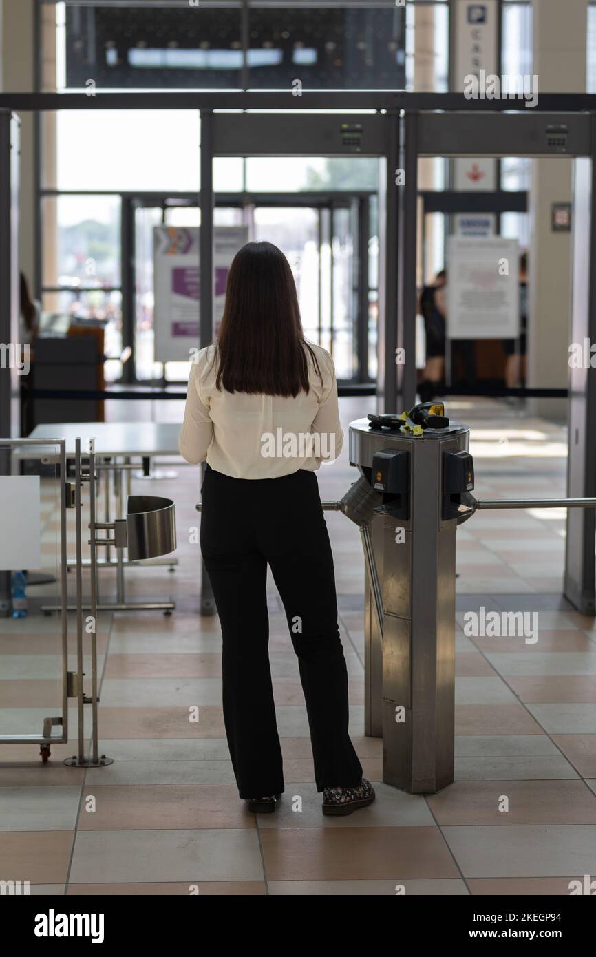 Security personnel checking bags and backpacks xrayed at the access
