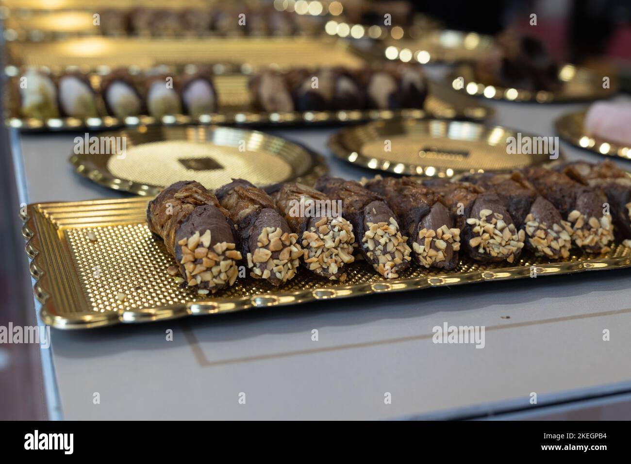 Italian Sweet Dessert, Traditional Sicilian Cannoli with Nuts and Chocolate Cream. Stock Photo