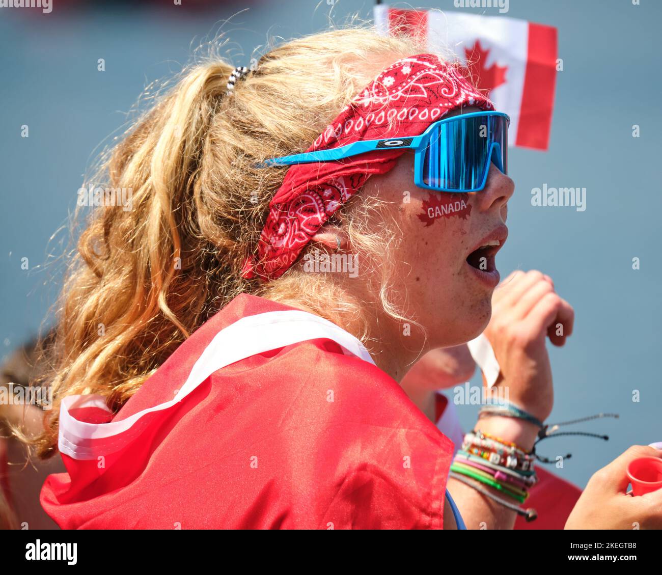 Canadian fan all dressed in red with flag and maple leaf cheek tattoo