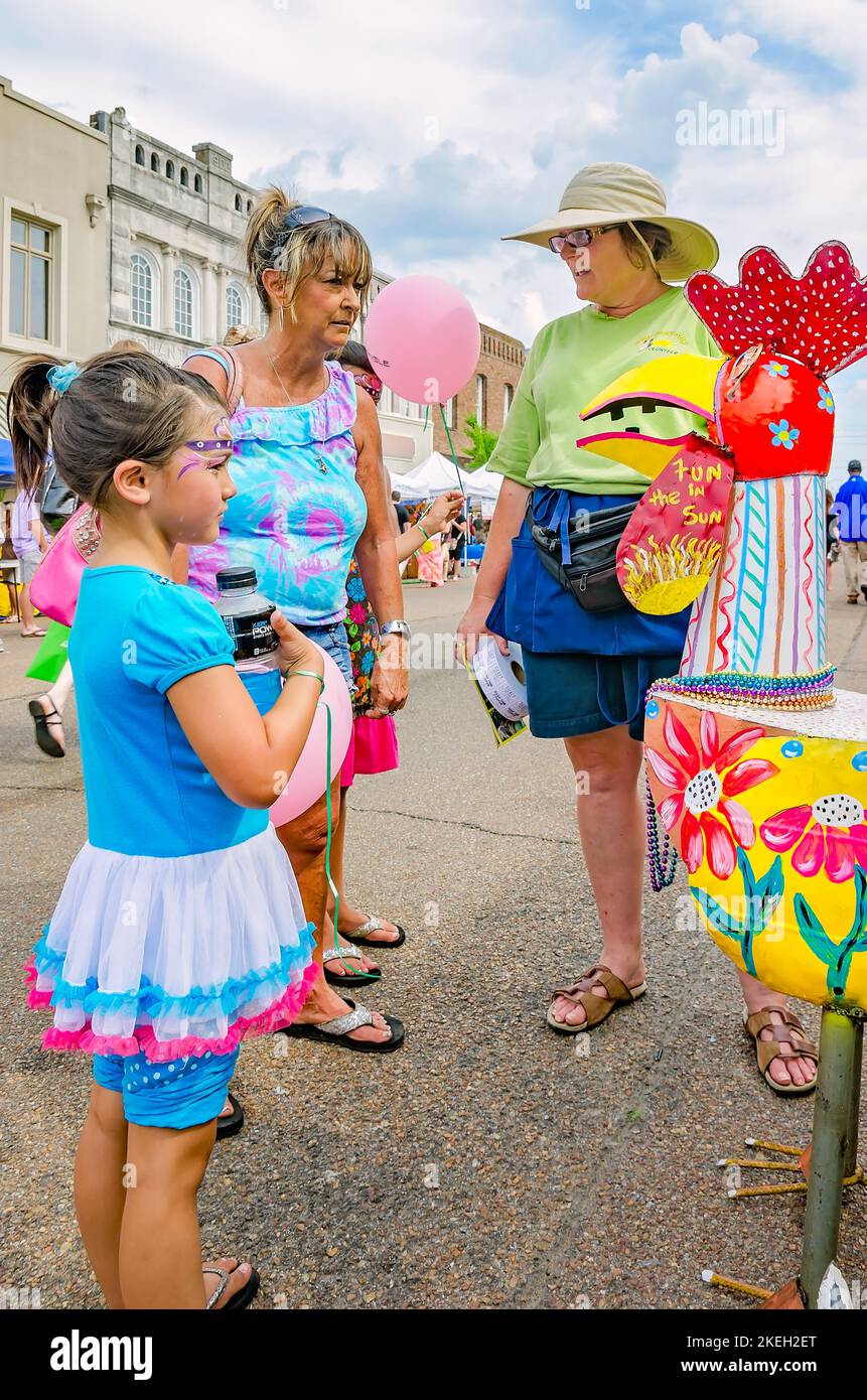 People discuss metal art during the Market Street Festival, May 5, 2012, in Columbus, Mississippi. Stock Photo