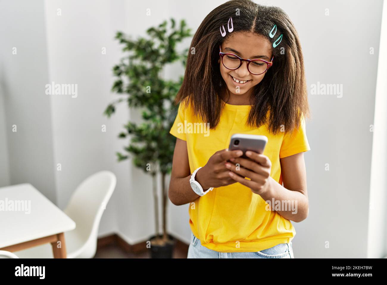 African american girl smiling confident using smartphone at home Stock ...
