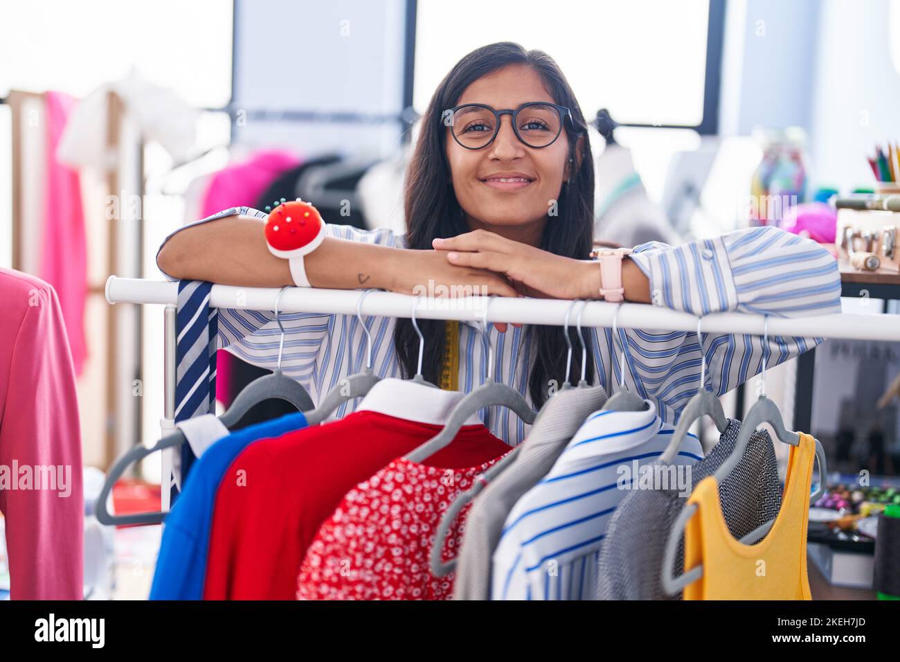 Hispanic Rack Young beautiful hispanic woman tailor smiling confident leaning on ...