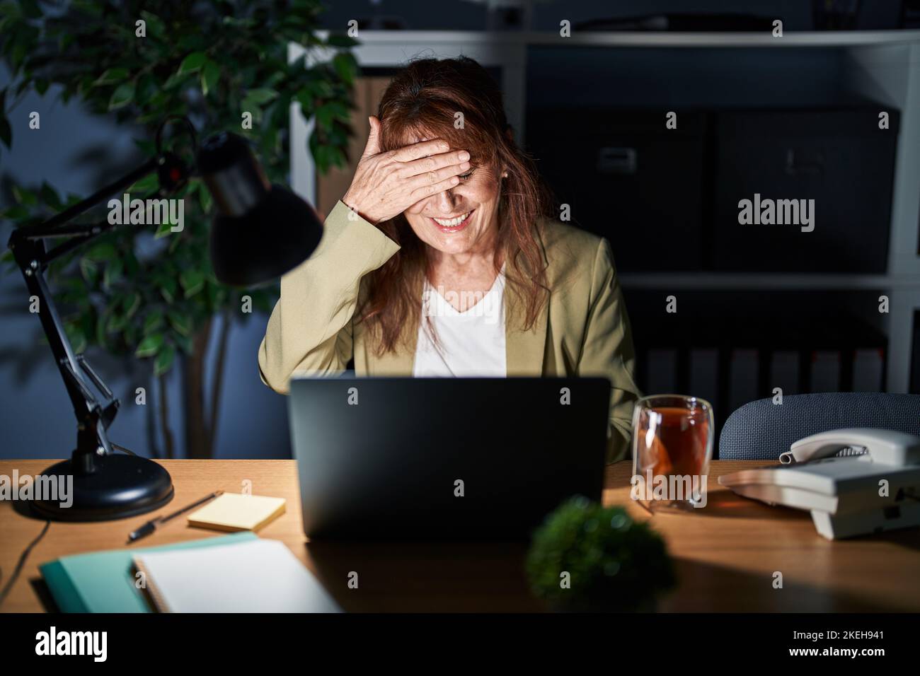 Middle age hispanic woman working using computer laptop at night ...