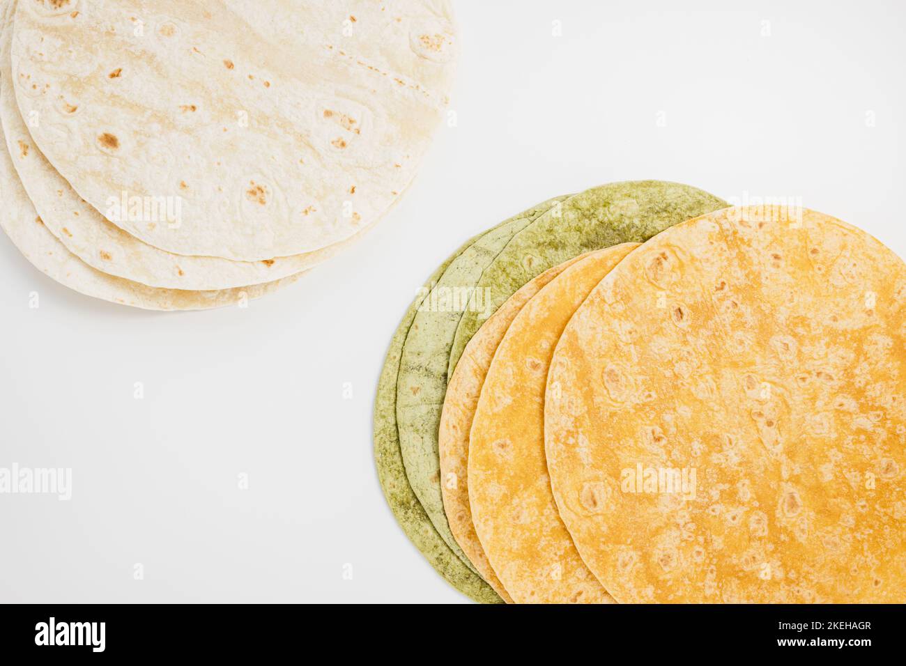 Tomato, spinach flavored and plain wheat tortilla wraps. Spanish or