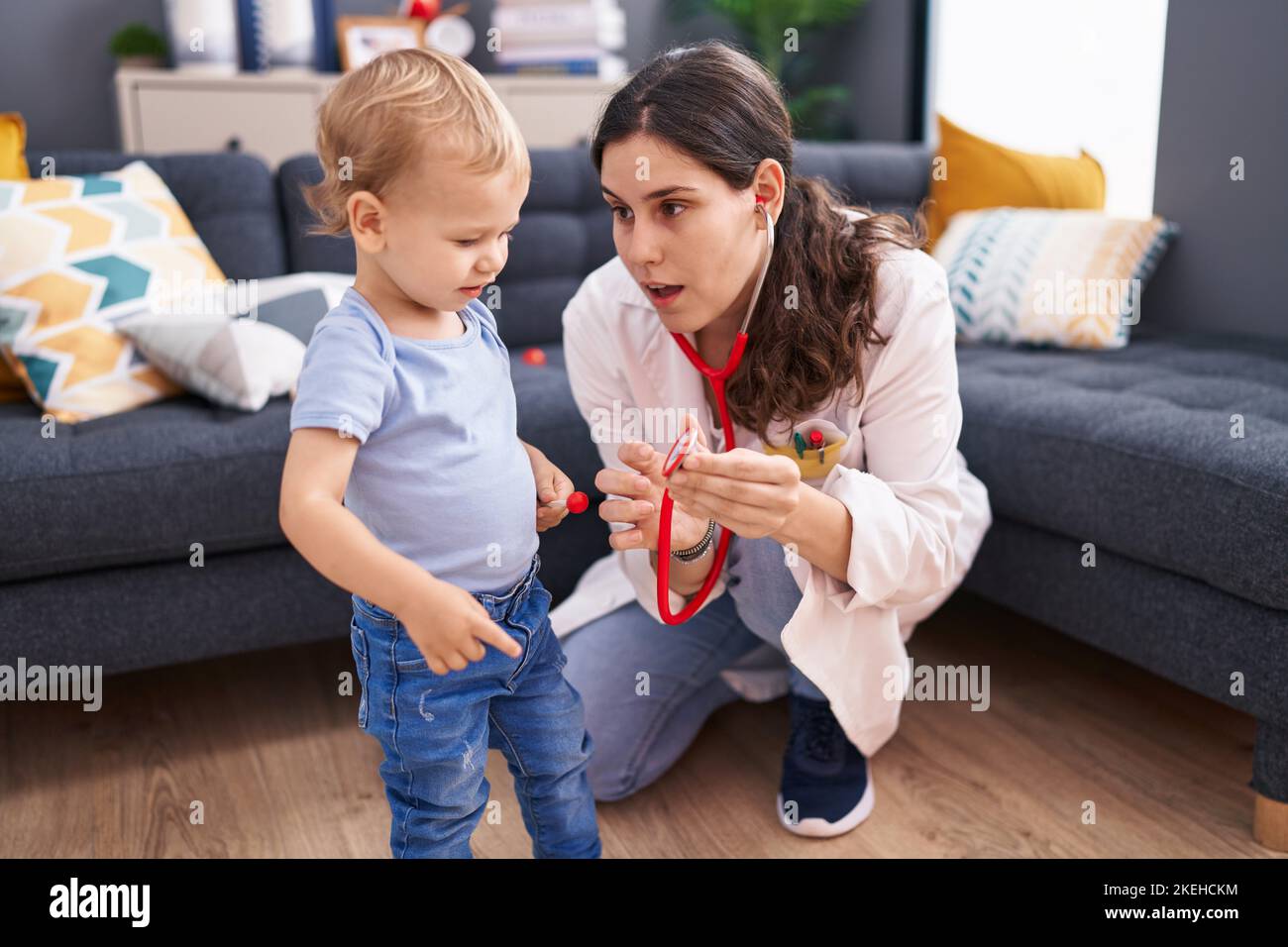 Mother and son doctor examining child at home Stock Photo - Alamy