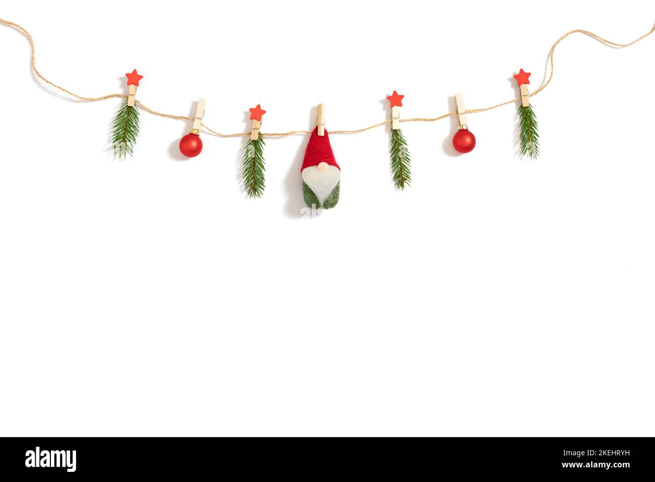 Christmas garland on a rope with fir branches, baubles and Santa ...