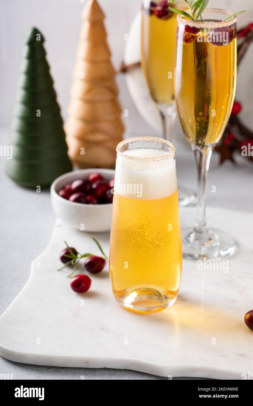 Festive Christmas mimosa with apple cider and cranberries Stock Photo