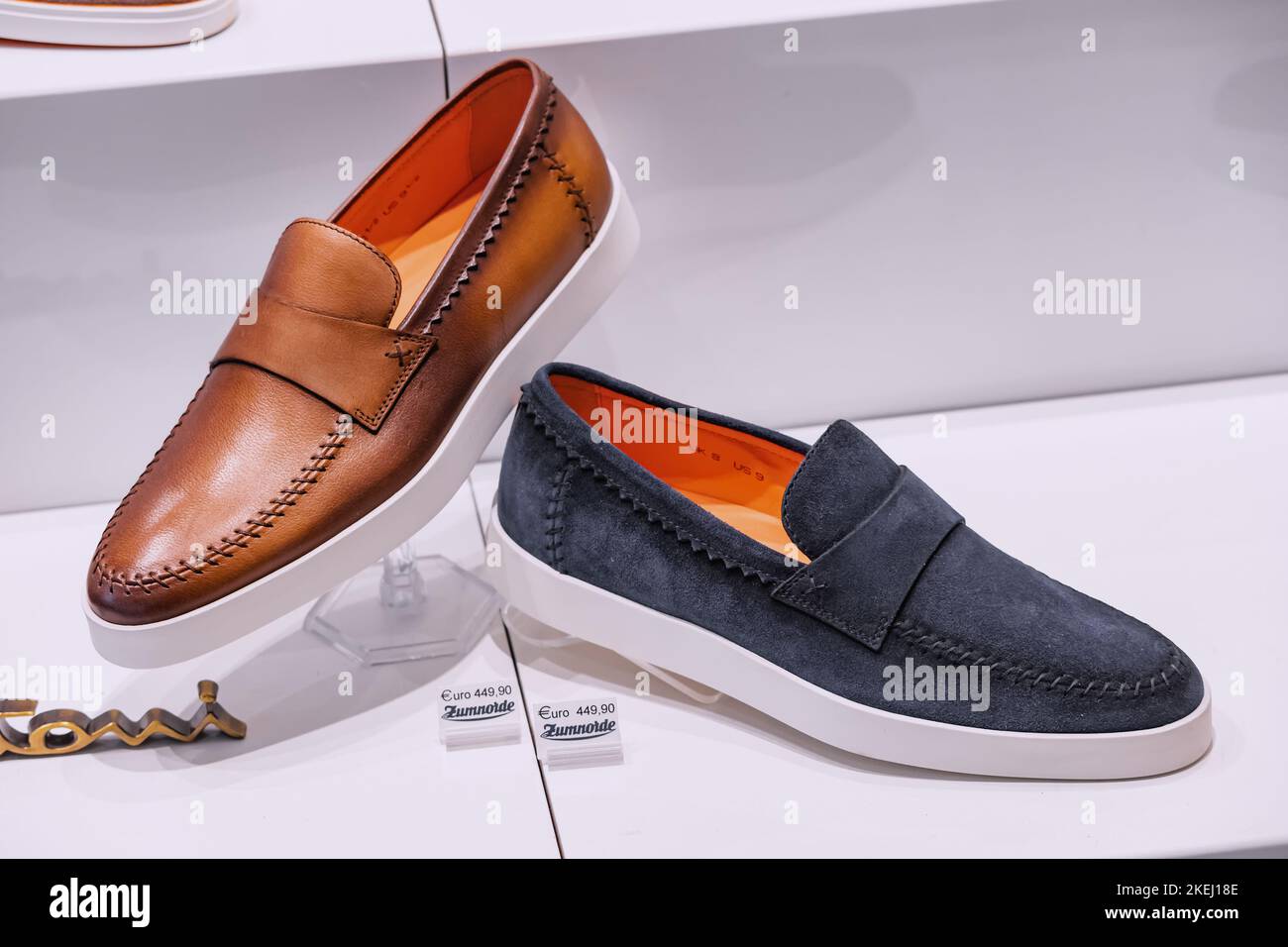 25 July 2022, Munster, Germany: Fashionable and vintage shoes or moccasins in the footwear shop window Stock Photo