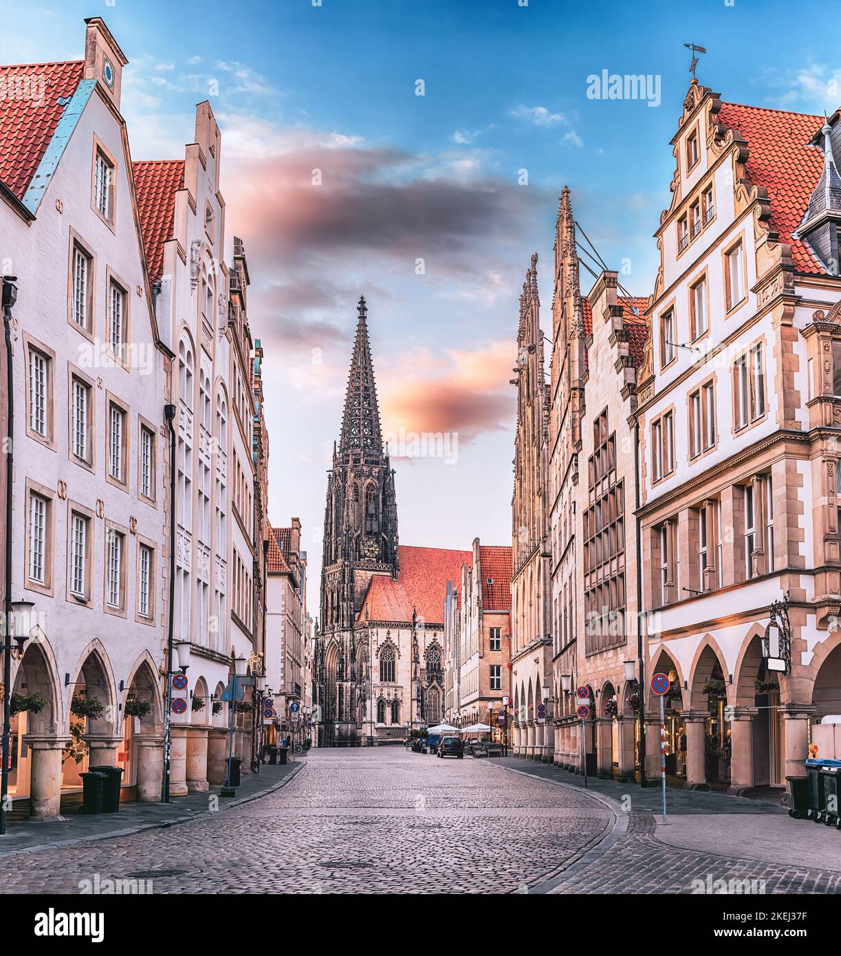 Scenic sunset view of Prinzipalmarkt square in Munster, Germany - without crowds of tourists at famous shopping street and tourist attraction. Saint L Stock Photo