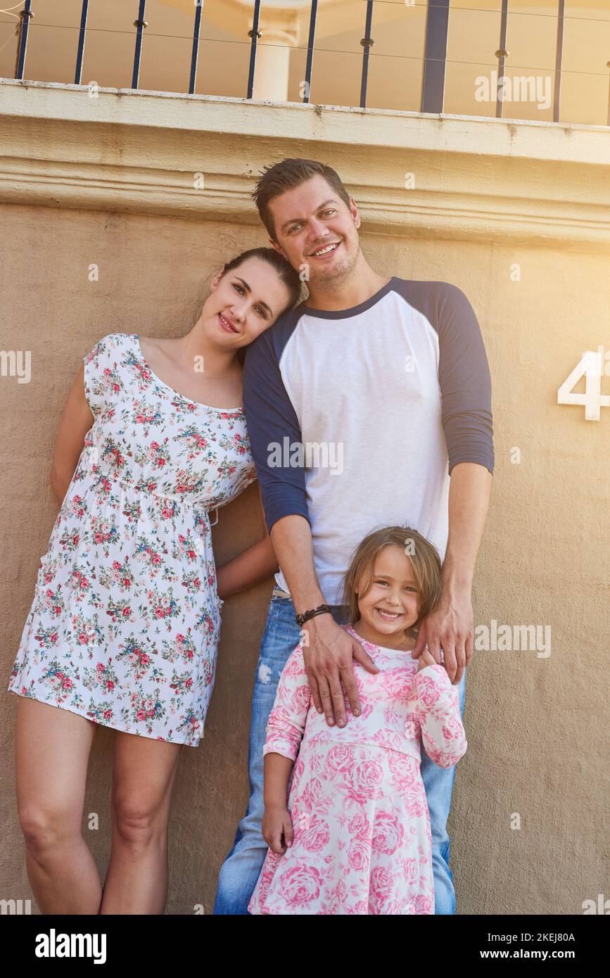 Together for life. Portrait of a happy family standing outside their house. Stock Photo