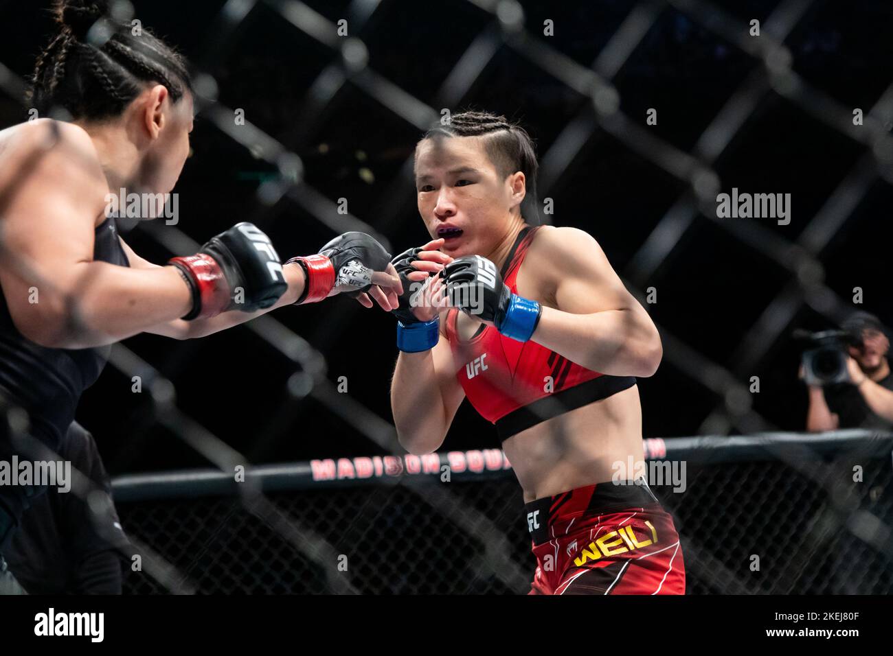 New York, USA. 12th Nov, 2022. Zhang Weili (R) of China and Carla Esparza of the United States compete during their women's strawweight title bout at the UFC 281 in Madison Square Garden in New York, the United States, Nov. 12, 2022. China's first UFC champion Zhang Weili reclaimed women's strawweight champion with a second-round submission on Carla Esparza at UFC 281 on Saturday night. Credit: Michael Nagle/Xinhua/Alamy Live News Stock Photo