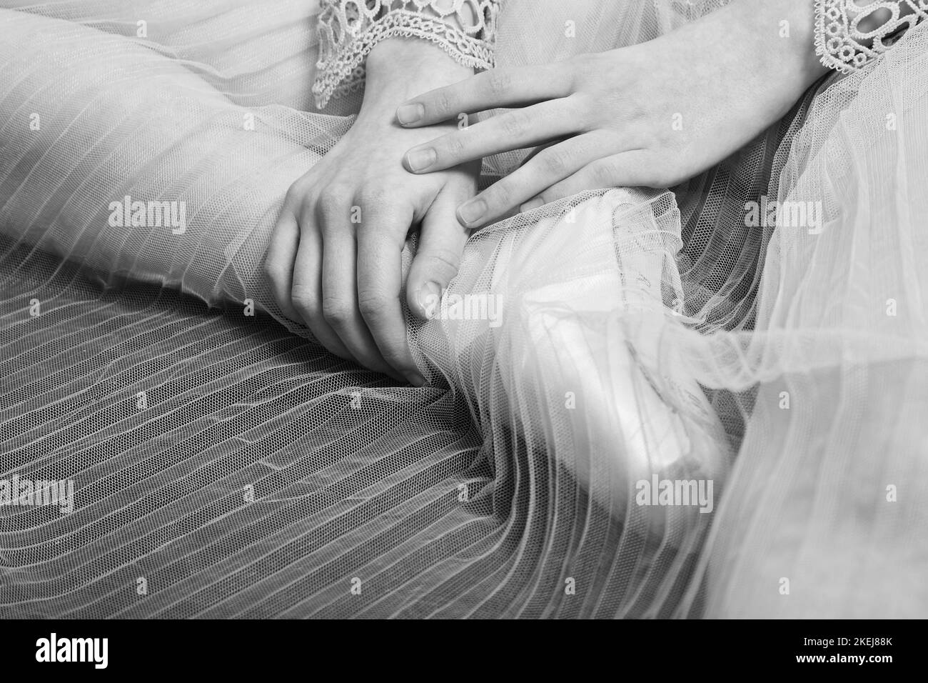 female ballerina feet in pointes on a wooden floor closeup monochrome