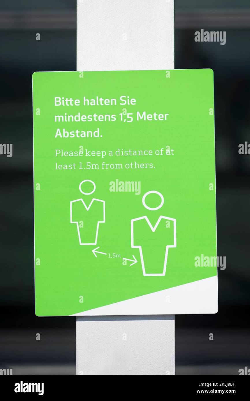 A green distance sign of 1,5 meters in an airport in Germany mounted on ...