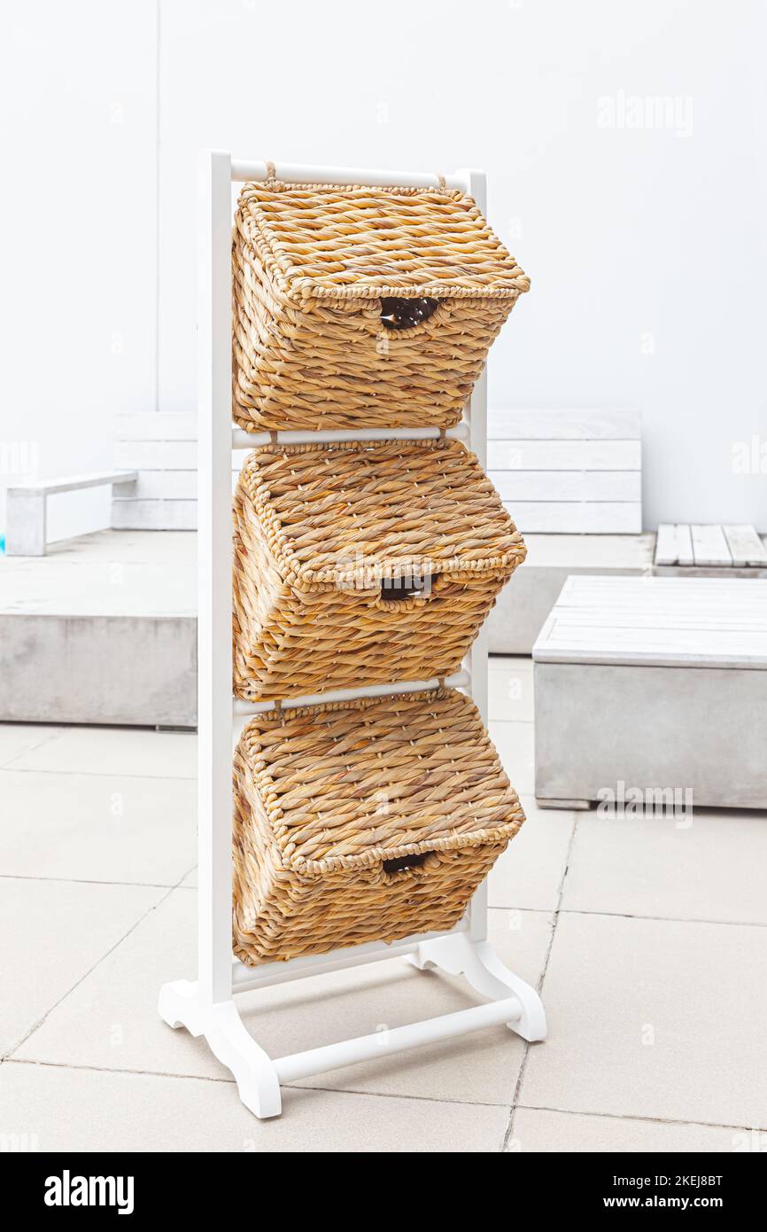 white wooden basket shelf stand with three decorative storage bins in