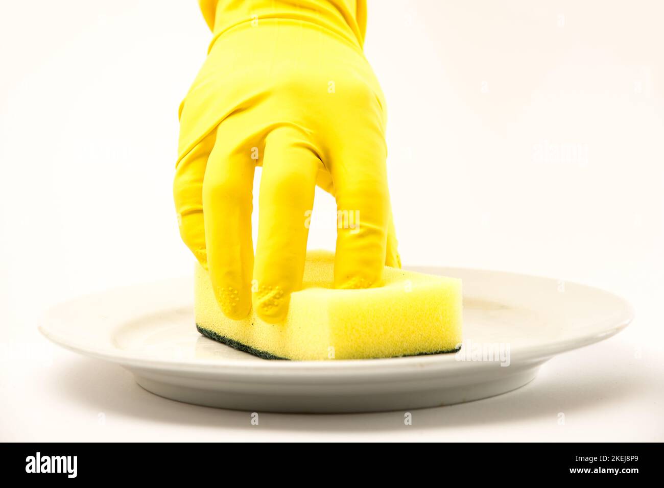 Dish washing. Yellow rubber gloves on hand Stock Photo Alamy