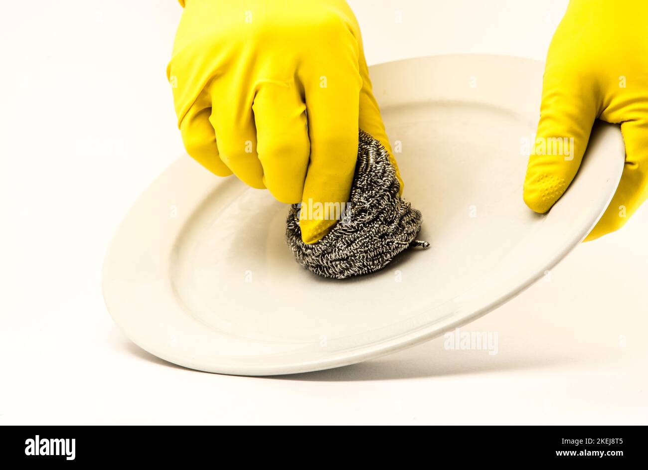 Dish washing. Yellow rubber gloves on hand Stock Photo Alamy