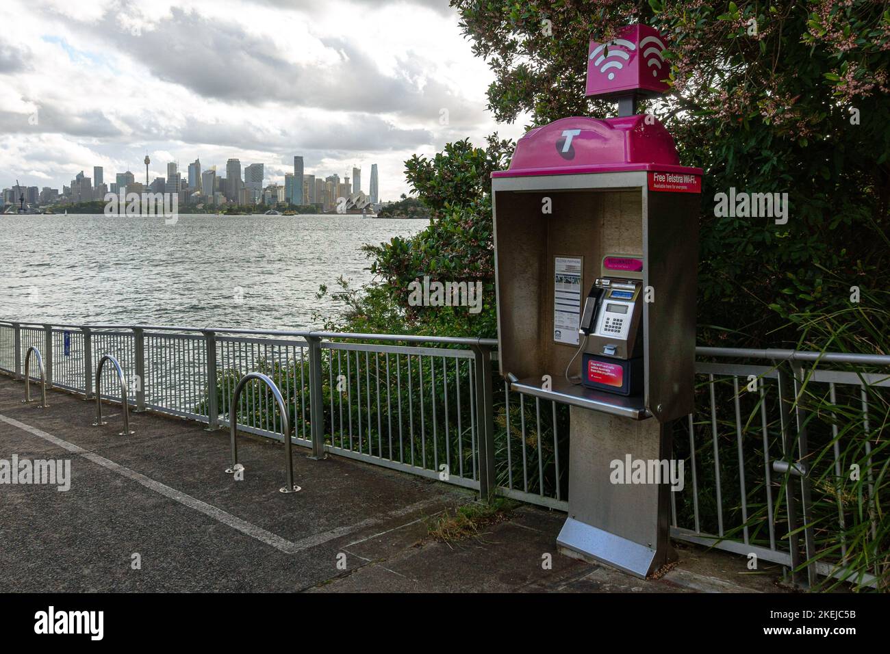 A Telstra payphone with the Sydney skyline in the back Stock Photo