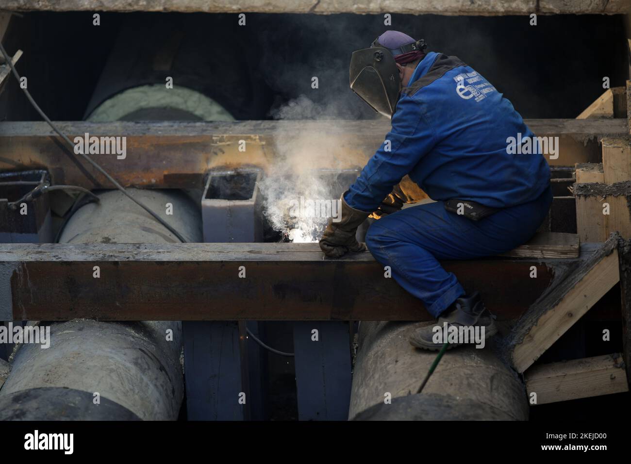 Bucharest, Romania - November 10, 2022: Details with a professional welder welding an industrial metallic pipeline. Stock Photo