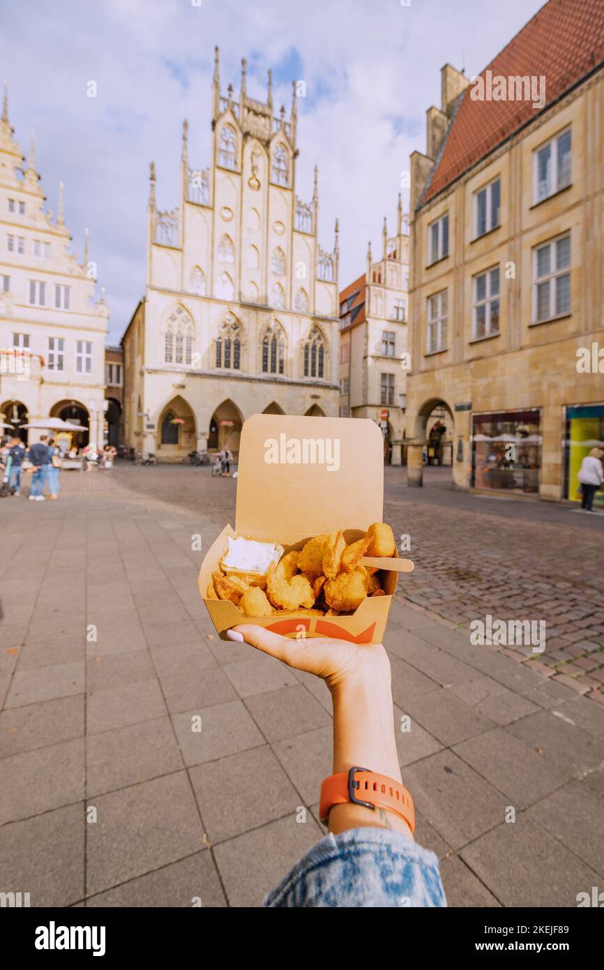 25 July 2022, Munster, Germany snacking on fast food shrimp in batter