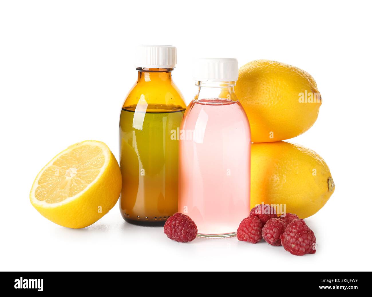 Bottles of cough syrup, lemons and raspberries on white background