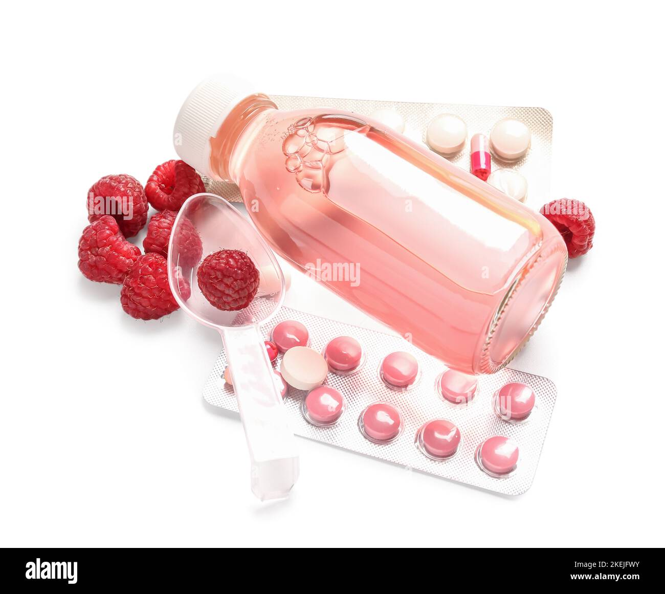 Pills for sore throat, cough syrup and raspberries on white background