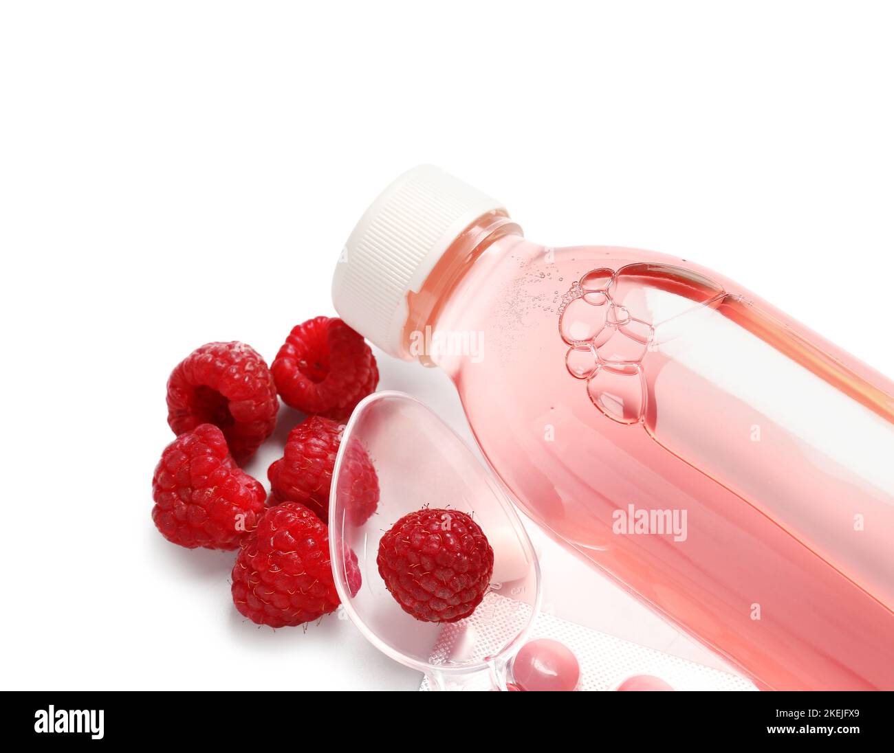 Cough syrup, spoon and raspberries on white background, closeup Stock Photo Alamy