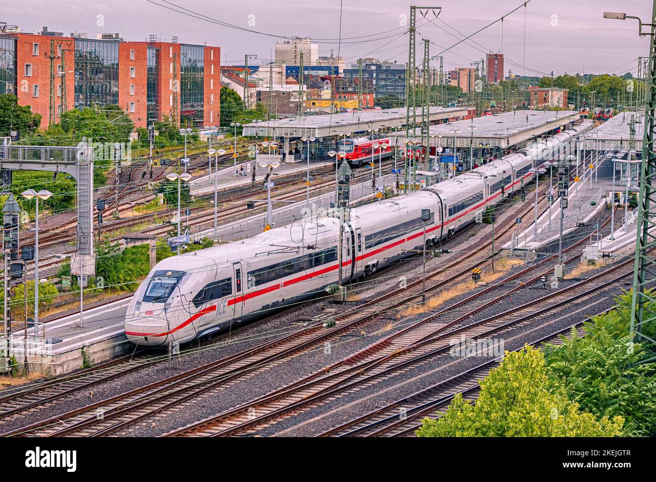 26 July 2022, Munster, Germany: modern high speed intercity DB Deutche Bahn train carries passengers. Branching of railway rails near stations and pla Stock Photo
