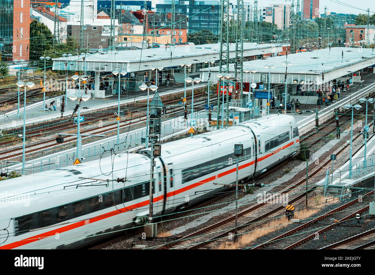 26 July 2022, Munster, Germany: modern high speed intercity DB Deutche Bahn train carries passengers. Branching of railway rails near stations and pla Stock Photo