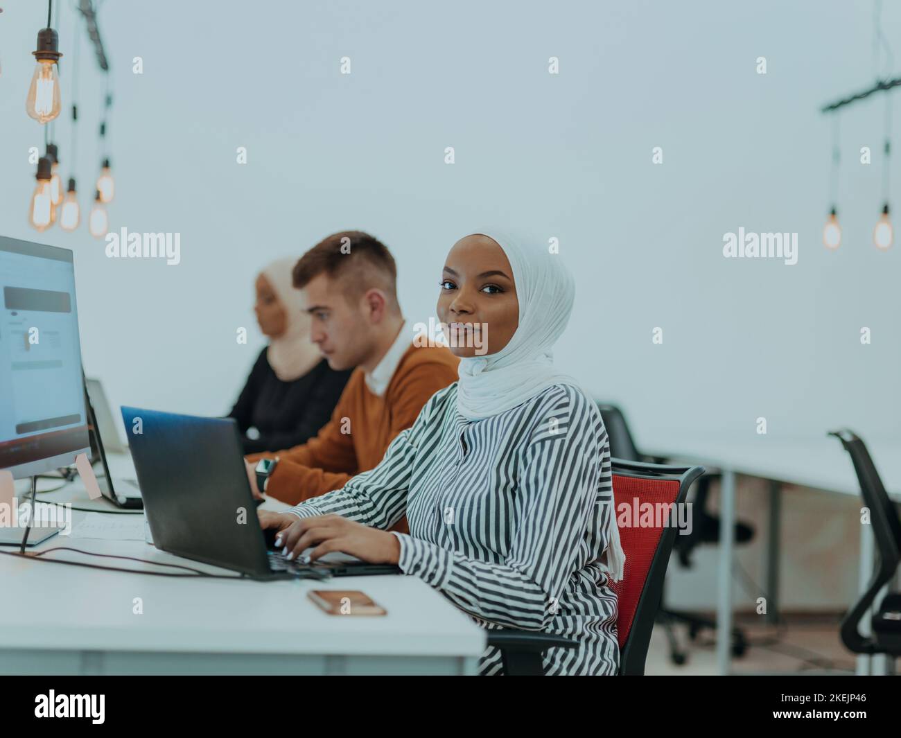 Group of multi-ethnic colleagues working on desktop computers, laptop ...
