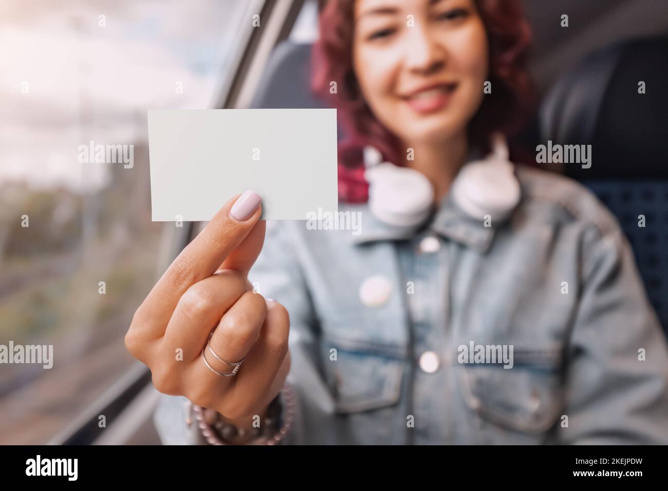 The girl shows her train ticket to the controller. Prices for travel and tourism Stock Photo