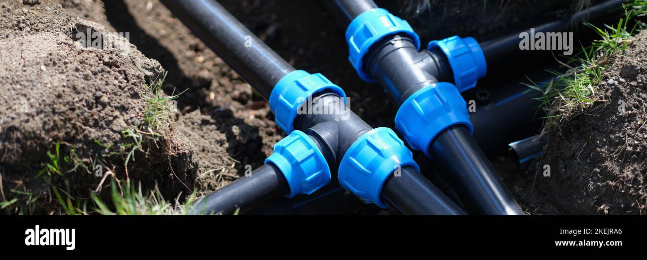 PVC pipeline in garden and black pipes in ground Stock Photo Alamy