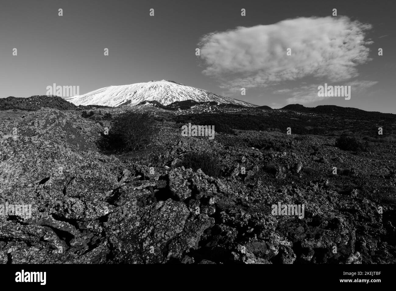 black and white snow covered Mount Etna and cloud in the National Park of Sicily, Italy Stock Photo