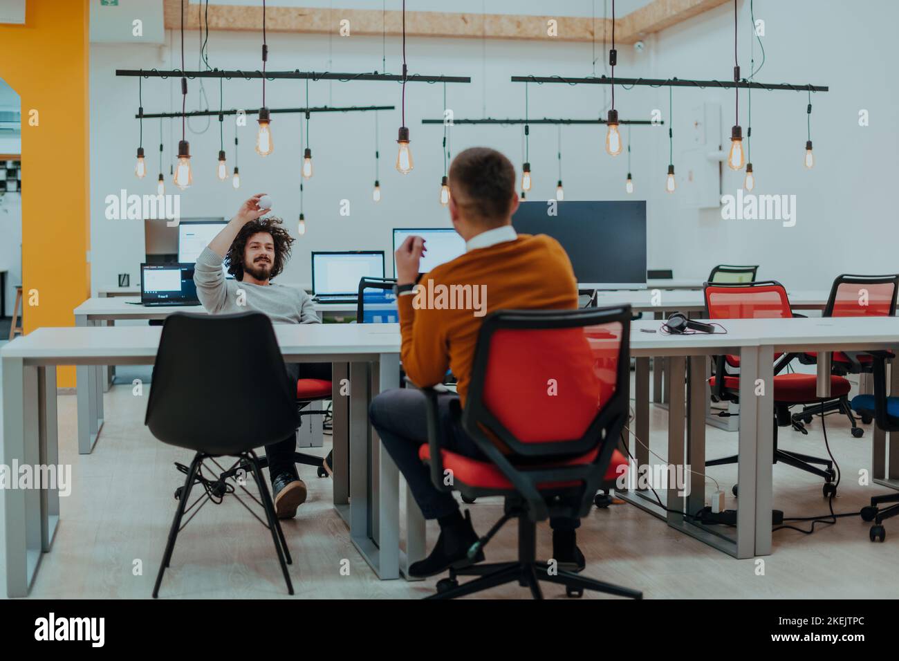 Two men having fun on a break from work in a modern office Stock Photo