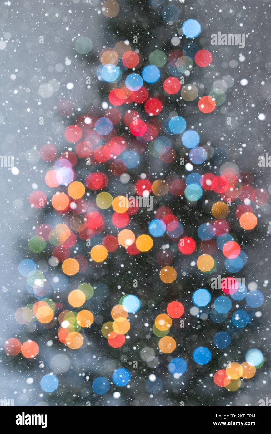 Christmas tree in multicolored lights and lots of snowflakes - soft focus Stock Photo