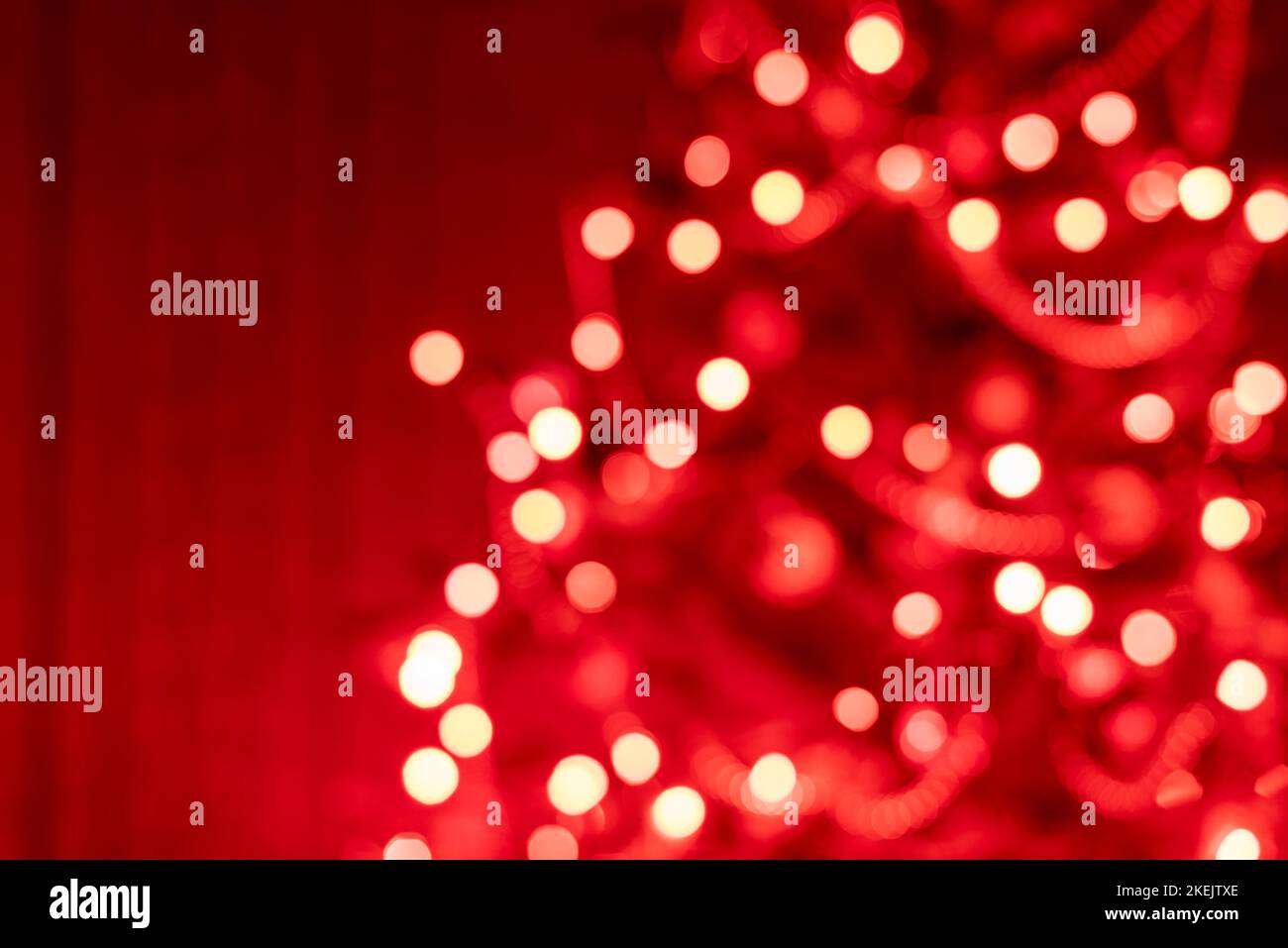 Part of a Christmas tree decorated with red lights - soft focus Stock Photo