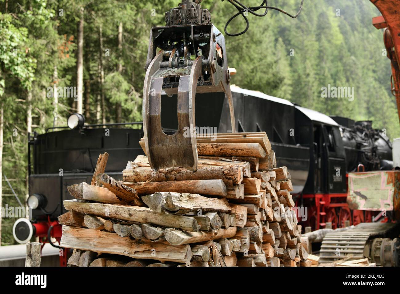 Scrap locomotive loading firewood into a vintage steam locomotive Stock ...