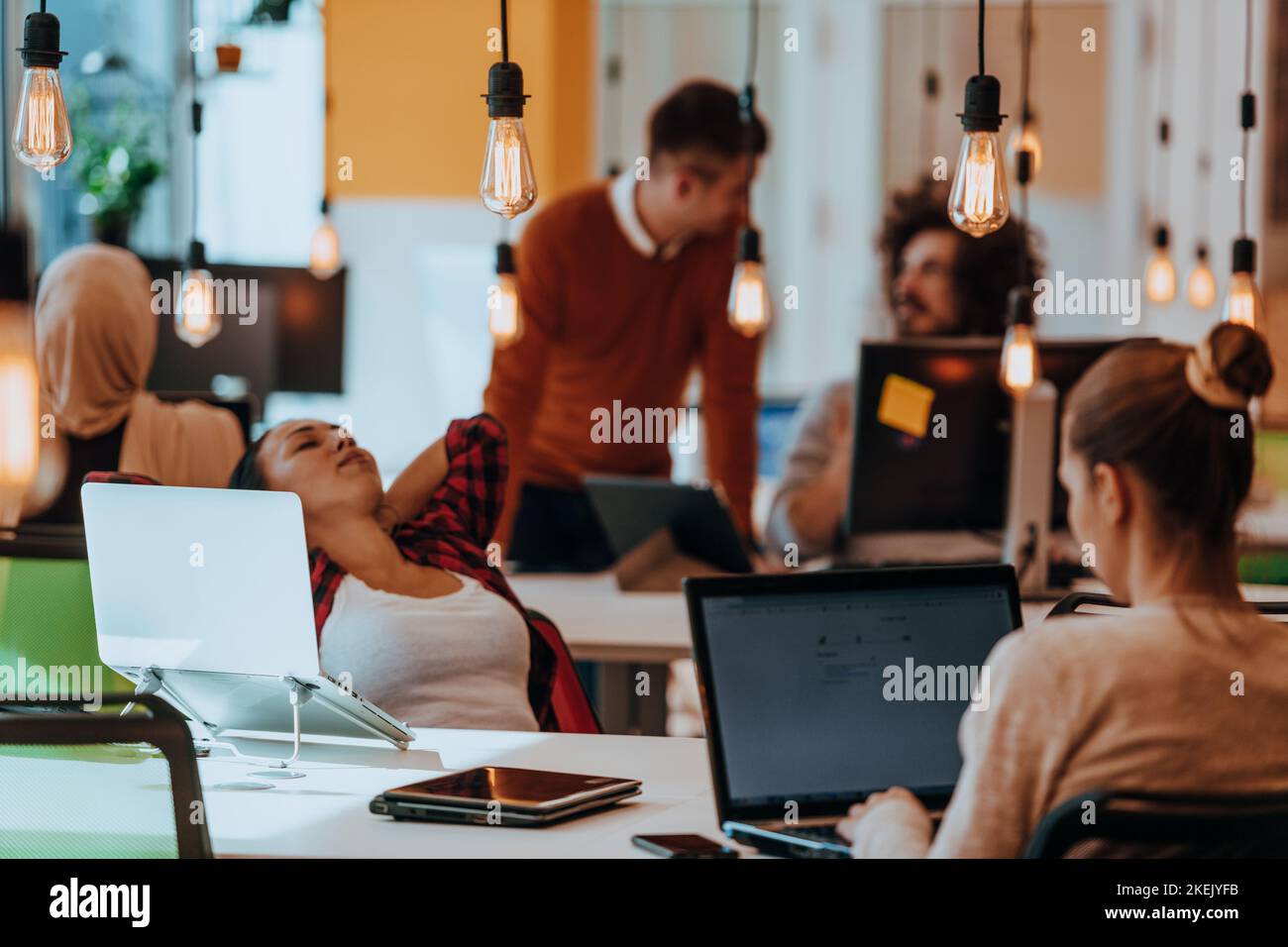 Group of multi-ethnic colleagues working on desktop computers, laptop ...
