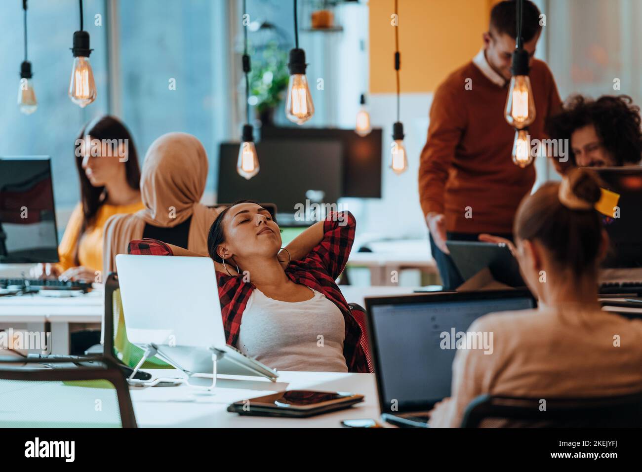 Group of multi-ethnic colleagues working on desktop computers, laptop ...