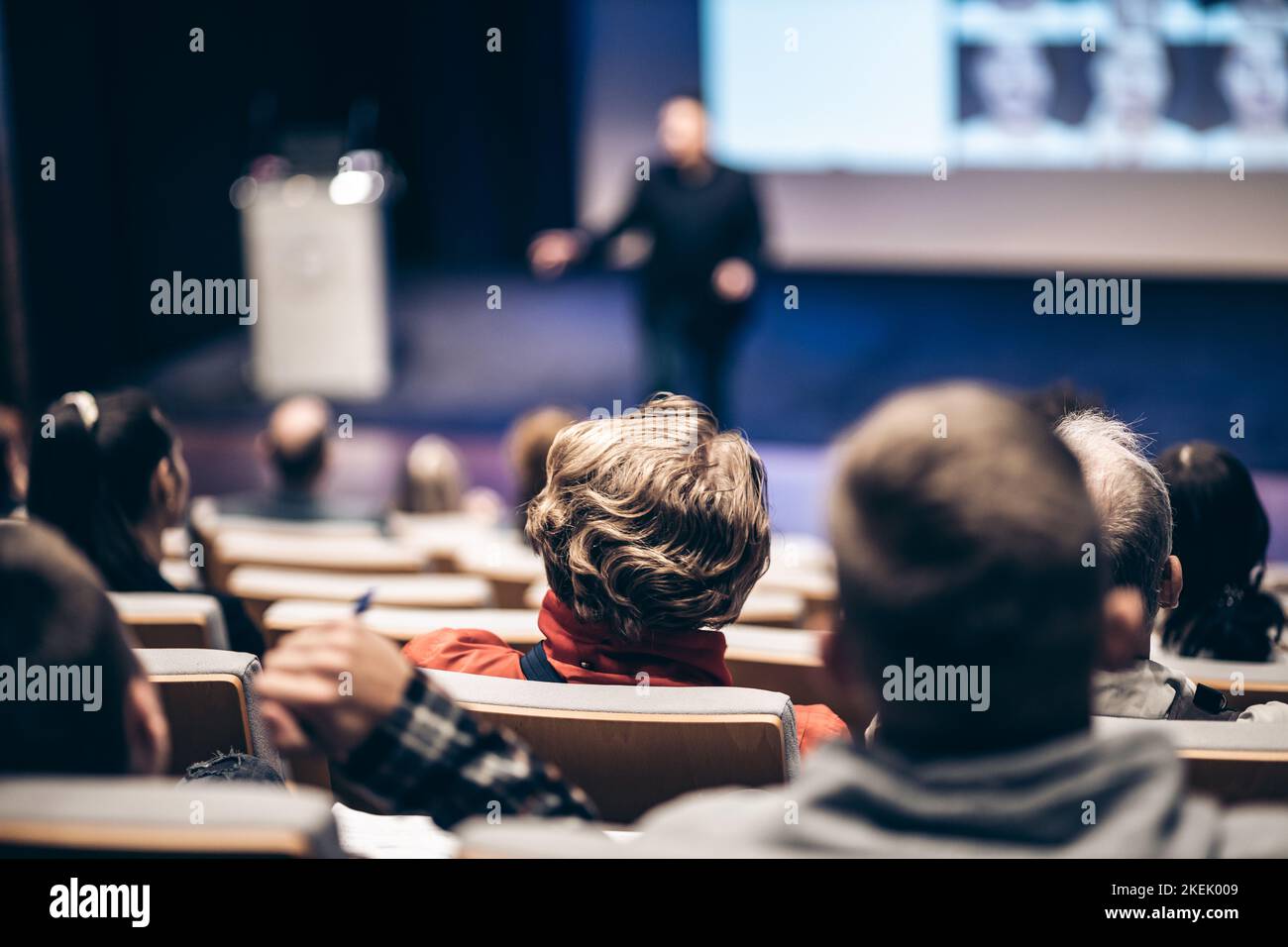 Speaker giving a talk in conference hall at business event. Rear view of unrecognizable people in audience at the conference hall. Business and entrepreneurship concept Stock Photo