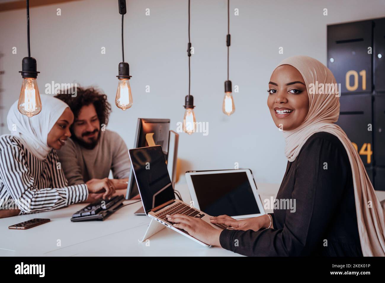 Group of multi-ethnic colleagues working on desktop computers, laptop ...