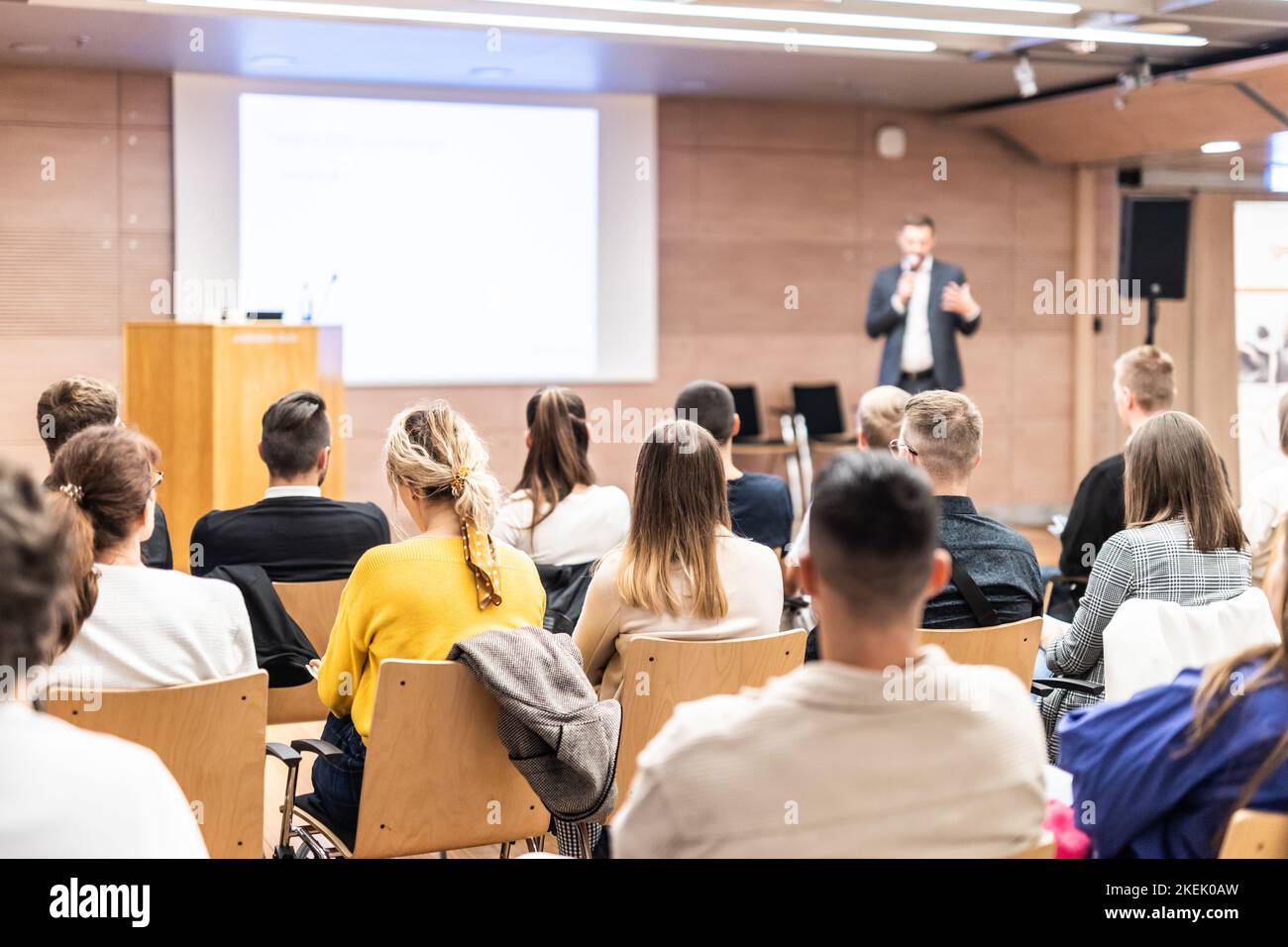 Speaker giving a talk in conference hall at business event. Rear view of unrecognizable people in audience at the conference hall. Business and entrepreneurship concept Stock Photo
