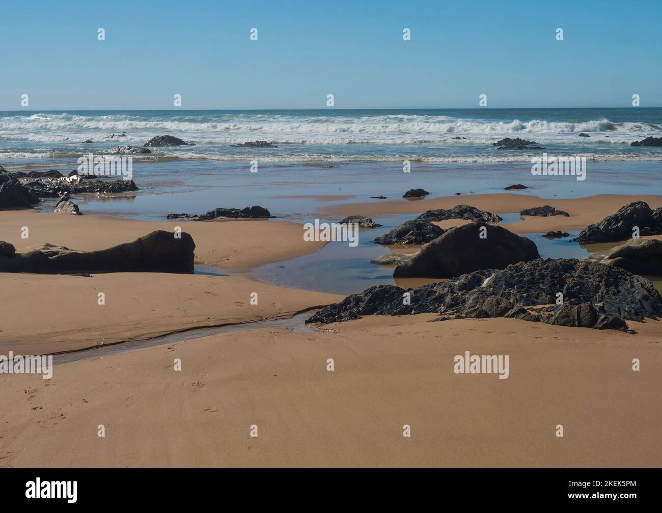View of empty Praia do Brejo Largo beach with ocean waves and sharp ...