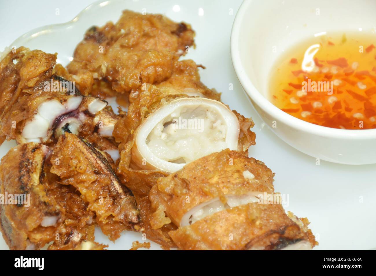 crispy fried squid stuffed flour dipping sweet chili sauce on plate