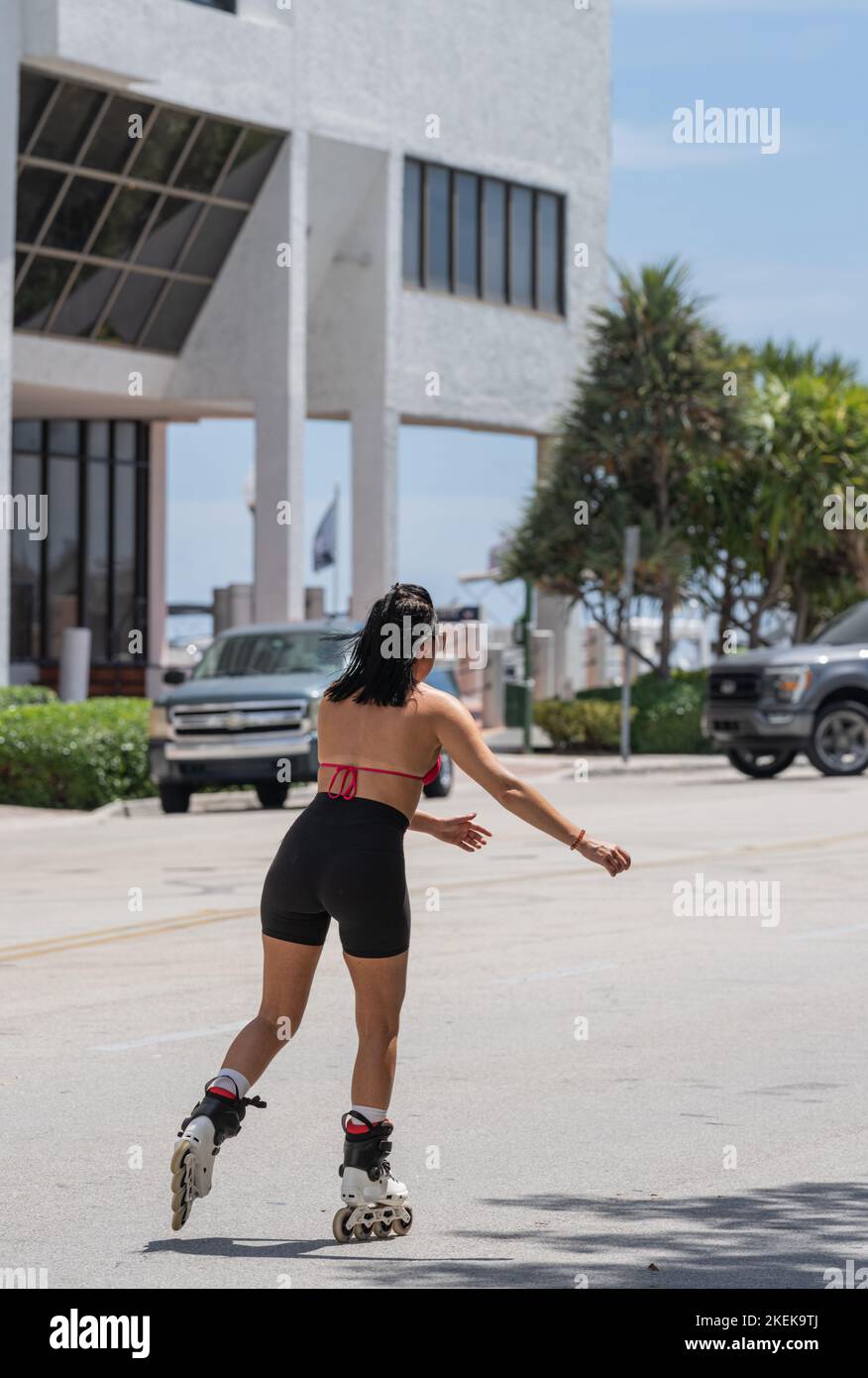 Body Blading Athletic girl in a swimsuit rollerblading down the street Stock Photo ...