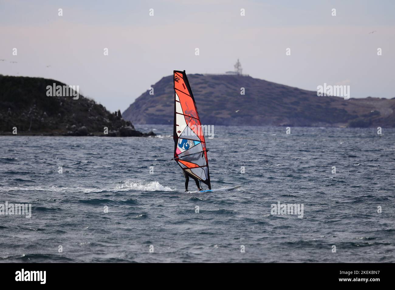 Bodrum, Mugla, Turkey. 23 September 2022 : An athlete doing windsurfing in the Aegean Sea. Stock Photo