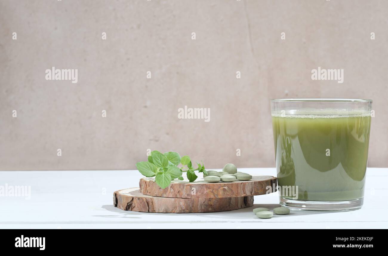 Healthy spirulina drink in the glass with spirulina chlorella tablets