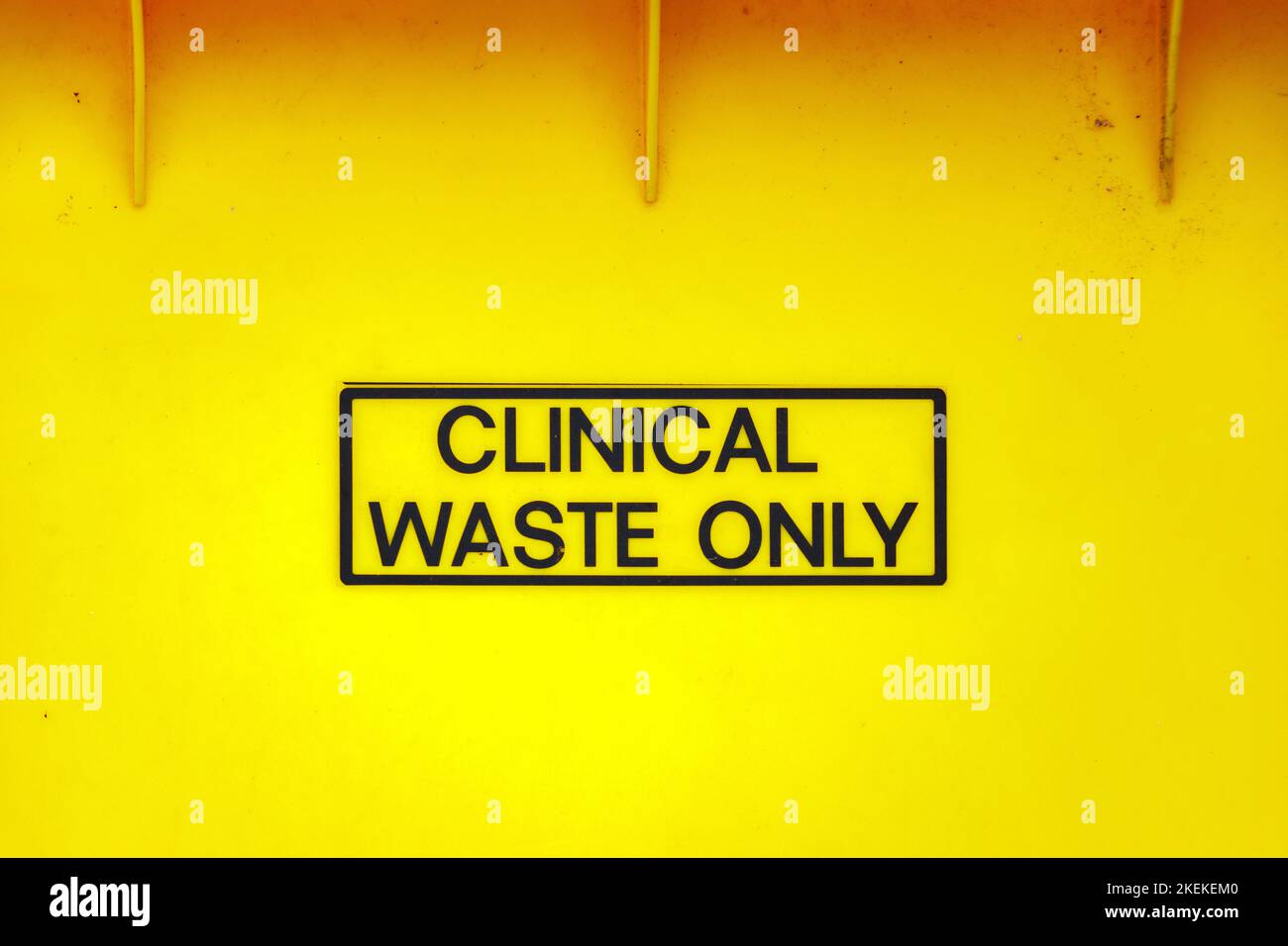 close up of lettering sign clinical waste only yellow plastic bin