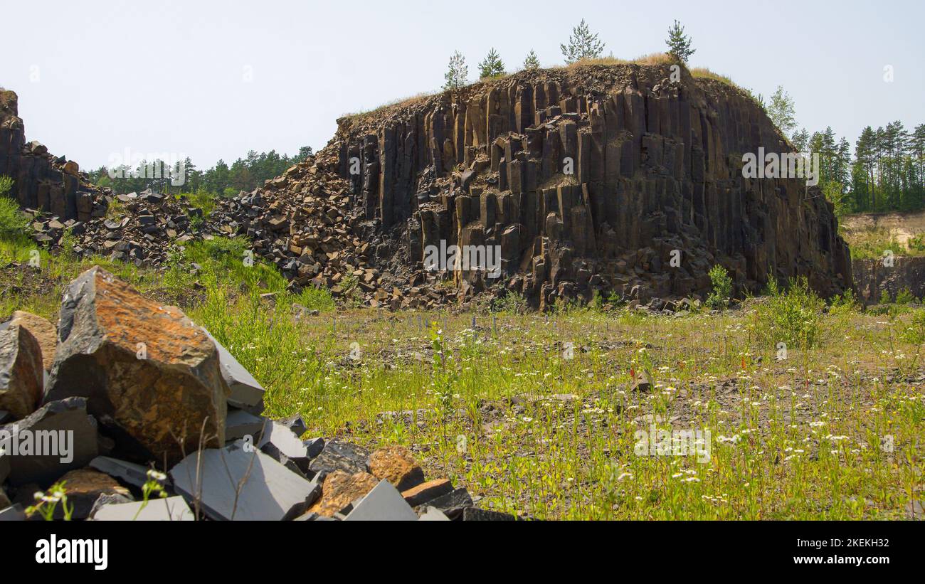 Abandoned basalt quarry. Basalt faceted rocks Stock Photo - Alamy