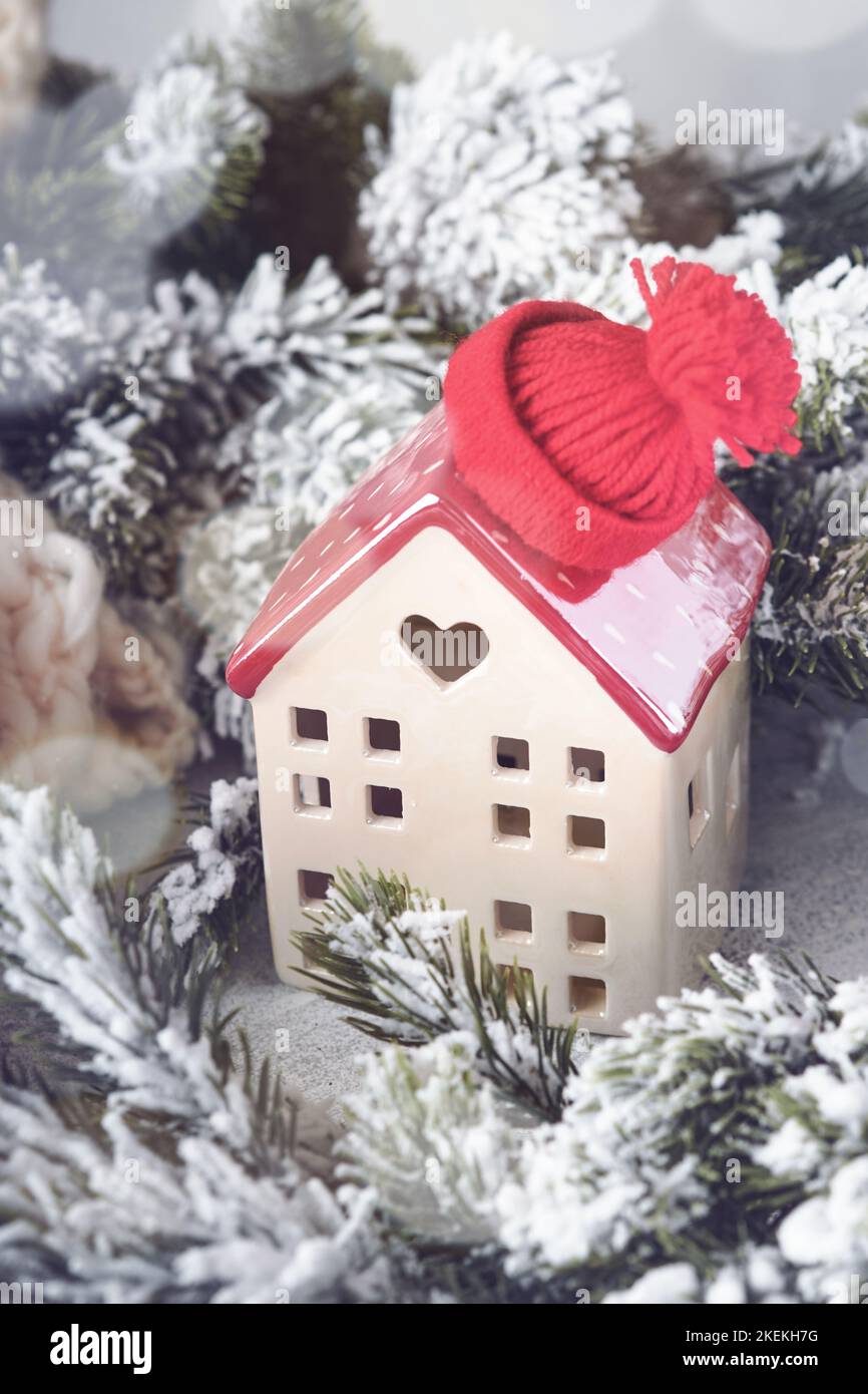 Christmas. New Year holiday card. Two houses wrapped in white scarf with Christmas tree branches in snow and beautiful bokeh. The concept of home holi Stock Photo